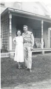 Mom and Dad standing in front of the stoop (10 days before my birth).